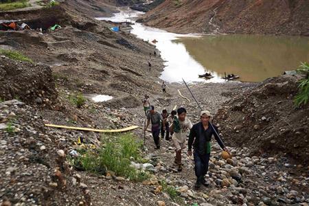 Hand-pickers return from searching for jade through rubble dumped by mining companies at a jade mine in Hpakant township, Kachin State