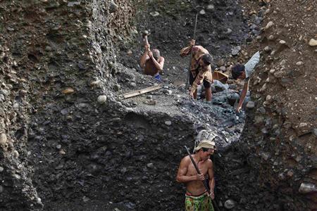 Hand-pickers search for jade through rubble dumped by mining companies at a jade mine in Hpakant township, Kachin State