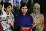 Nobel Peace Prize laureate Malala Yousafzai (C) is joined by young women activists Sahazia Ramzan of Pakistan (L) and Mezon Almellehan of Syria, who she invited to accompany her, in Oslo December 9, 2014. Pakistani teenager Yousafzai will receive the Nobel Peace Prize at an award ceremony on Wednesday. Yousafzai, who was shot in the head by the Taliban in 2012 for advocating girls' right to education, has won the prize along with Indian campaigner against child trafficking and labor, Kailash Satyarthi. REUTERS/Suzanne Plunkett (NORWAY - Tags: SOCIETY)