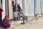 Families outside their temporary homes at the Nizip 2 Container City, the newest of Turkey's camps for displaced Syrians. It currently shelters 1732 and has a capacity for 5,000. It was opened on February 15th and will likely be full by March 30. 
 PHOTO BY JODI HILTON