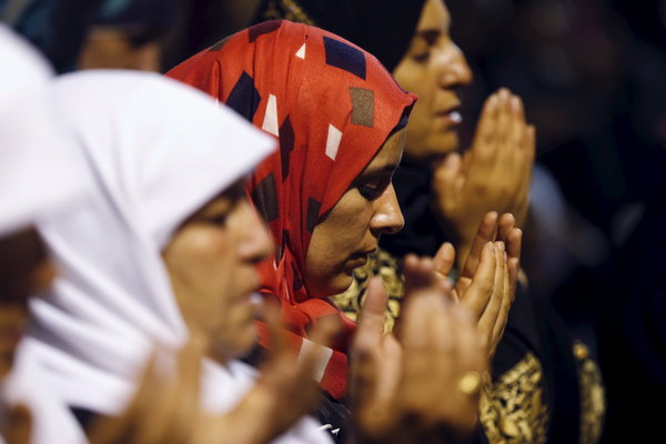 Female Palestinian worshippers pray in front of the Dome of the Rock, in the Al Aqsa Mosque compound in Jerusalem during Ramadan July 13, 2015, on Lailat-Al-Qadr, or Night of Power, in which the Muslim holy book of Koran was revealed to Prophet Mohammad by Allah. The compound is also known as Temple Mount to the Jews. REUTERS/Ammar Awad