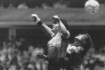 FILE - In this June 22, 1986 file photo  Argentina's Diego Maradona, left, beats England goalkeeper Peter Shilton to a high ball and scores his first of two goals in a World Cup quarterfinal soccer match, in Mexico City. On this day: This was the day of the Hand of God, when Maradona used his left fist to knock a ball past England's Shilton. (AP Photo/El Grafico, Buenos Aires, File)