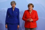 German Chancellor Angela Merkel greets Britain's Prime Minister Theresa May as she arrives for the G20 leaders summit in Hamburg, Germany July 7, 2017. REUTERS/Kai Pfaffenbach
