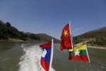 Flags flutter on a boat while a delegates from China's Narcotics Control Bureau, the United Nations Office on Drugs and Crime (UNODC), Laos, Myanmar and Thailand travel on an inspection trip on the Mekong river near the border between China, Laos and Myanmar March 1, 2016. Patrols on the Mekong River by the Laotian army and Myanmar police have subdued pirates who once robbed cargo ships with impunity. But drug production and trafficking in the region, known as the Golden Triangle, is booming - despite the presence of Chinese gunboats and Chinese armed police. The United Nations Office on Drugs and Crime estimates that Southeast Asia's trade in heroin and methamphetamine was worth $31 billion in 2013. REUTERS/Jorge Silva SEARCH "SILVA MEKONG" FOR THIS STORY. SEARCH "THE WIDER IMAGE" FOR ALL STORIES
