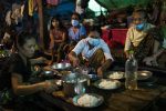 People prepare dinner at the Shitthaung camp for displaced people in Mrauk-U on Aug. 20. International humanitarian access to the township has been largely blocked since early 2019, and many camps are run by local civil society organizations and community volunteers. Hkun Lat for Foreign Policy