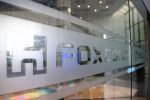 FILE PHOTO:  A sign of Foxconn is seen at a glass door inside its office building in Taipei, Taiwan November 12, 2020. REUTERS/Ann Wang/File photo