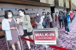 Peoples queueing for the walk-in vaccination at the IDCC PPV in Shah Alam yesterday. — IZZRAFIQ ALIAS/The Star
