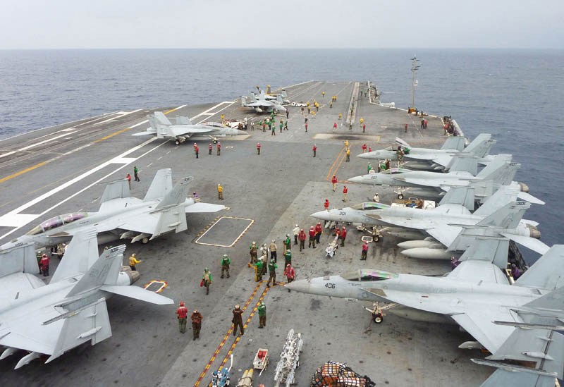 U.S. Navy FA-18 Hornets park on the flight deck of the USS George Washington during the Annual Exercise 2013, at sea