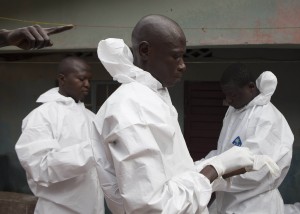 Burial team prepare to enter the home suspected Ebola virus victim in Freetown