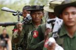 Army soldiers carry weapons as they walk to the earthquake struck area in Tarlay, Myanmar March 28, 2011.  REUTERS/Soe Zeya Tun