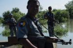 In this photo taken on October 15, 2016, armed Myanmar border guard  patrol the border area along the river dividing Myanmar and Bangladesh located in Maungdaw, Rakhine State following attacks that killed nine border police. 
The government says the October 9 border raids were carried out by hundreds of Rohingya fighters linked to Taliban-trained Islamists. Rights groups are piling pressure on Myanmar to allow an impartial probe into allegations that soldiers are killing, raping and torturing villagers in a security crackdown in Rakhine, a restive region home to the persecuted Muslim Rohingya. / AFP PHOTO / YE AUNG THU