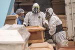 Worker move a coffin with the body of a COVID-19 victim out of a refrigerated container before its cremation at the El Angel crematorium, in Lima on May 21, 2020 - Peru has become the second Latin American country after Brazil to reach 100,000 coronavirus cases, according to health ministry figures out Wednesday. (Photo by Ernesto BENAVIDES / AFP) (Photo by ERNESTO BENAVIDES/AFP via Getty Images)