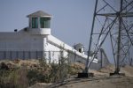 (FILES) this file photo taken on May 30, 2019 shows watchtowers on a high-security facility near what is believed to be a re-education camp where mostly Muslim ethnic minorities are detained, on the outskirts of Hotan, in China's northwestern Xinjiang region. - The US announced September 14, 2020 it would block a range of Chinese products made by "forced labor" in the Xinjiang region, including from a "vocational" center that it branded a "concentration camp" for Uighur minorities. (Photo by GREG BAKER / AFP)