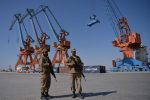 TO GO WITH 'PAKISTAN-ECONOMY-POVERTY' by Ashraf KHAN

In this photograph taken on November 13, 2016, Pakistani Naval personnel stand guard near a ship carrying containers at the Gwadar port, some 700 kms west of Karachi, during the opening ceremony of a pilot trade programme between Pakistan and China. - Shah Nawaz walks Karachi's dusty streets, one of thousands in the financial hub who are being fed by charities as Pakistan's economy picks up pace -- but, some say, not fast enough for its poverty-stricken millions. Confidence in Pakistan is growing, with the International Monetary Fund claiming in October 2016 that the country has emerged from crisis and stabilised its economy after completing a bailout programme. (Photo by AAMIR QURESHI / AFP) / TO GO WITH 'PAKISTAN-ECONOMY-POVERTY' BY ASHRAF KHAN