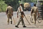 GREATER NOIDA, INDIA - SEPTEMBER 29: Police on alert after violence over murder of a man over allegations of sacrificing a cow at village Bisada on September 29, 2015 in Greater Noida, India. Afzal, 36, a resident of Bisara area under Jarcha police station of Greater Noida, was dragged out of his house and beaten to death after residents alleged that he had sacrificed a cow in his house. The incident triggered violent protests in the area and a police vehicle was burnt. (Photo by Burhaan Kinu/Hindustan Times via Getty Images)